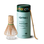 Explore the Matcha Bamboo Whisk & Holder Set, featuring a bamboo scoop and a premium matcha whisk, elegantly packaged in a sleek cylindrical design.