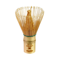 The eco-friendly Bamboo Matcha Whisk (100 Prongs) with a carved handle is perfect for traditional Japanese tea ceremonies, set against a pristine white background.