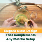 A person whisks matcha in a glass bowl on a wooden tray with the text: "Clear Glass Matcha Whisk Holder and Bamboo Whisk Set—an elegant design that enhances any tea set.