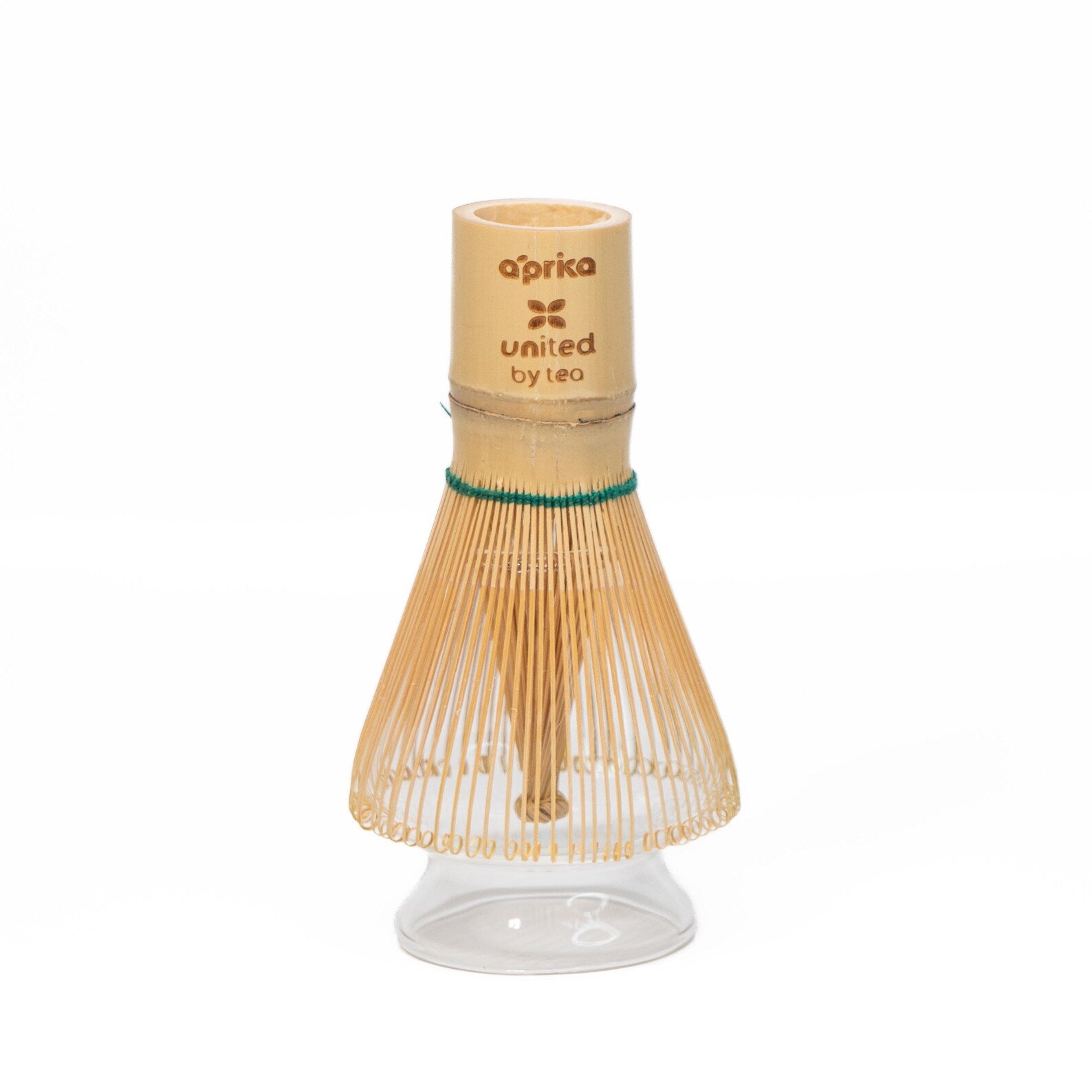 The Clear Glass Matcha Whisk Holder and Bamboo Whisk Set is shown with the bamboo whisk resting on the glass holder against a white background, making it an ideal addition to any matcha tea set.