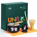 The Black Unfurl Matcha Gift Set includes a kawaii cat bowl, bamboo whisk, and comes in a green “UNfurl” box with cat illustrations—perfect for tea lovers.