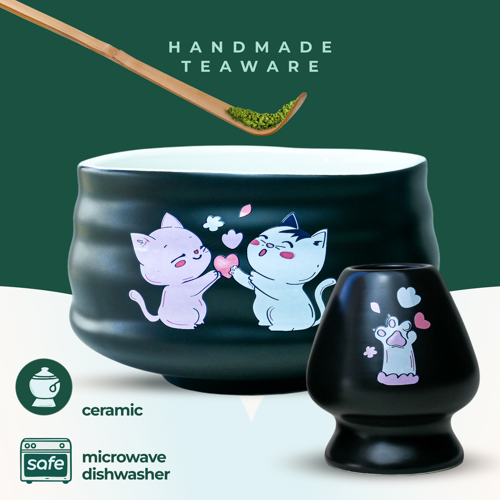 The Black Unfurl Matcha Gift Set includes black ceramic teaware with kawaii cat bowl designs. Each piece is labeled handmade and is both microwave and dishwasher safe.