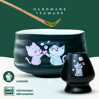 The Black Unfurl Matcha Gift Set includes black ceramic teaware with kawaii cat bowl designs. Each piece is labeled handmade and is both microwave and dishwasher safe.