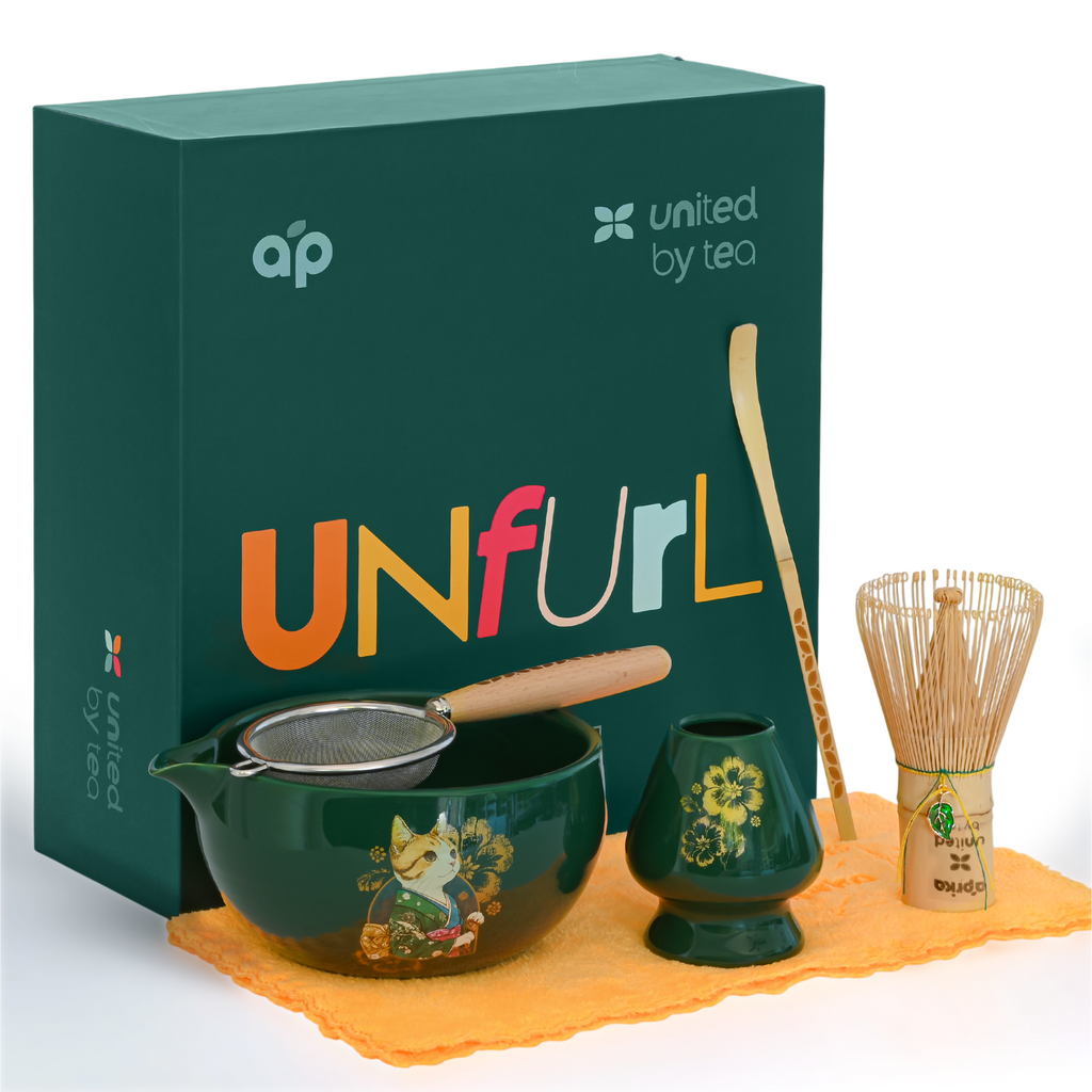 The Green Unfurl Matcha Gift Set includes a matcha bowl, whisk, strainer, scoop, and towel—all elegantly presented with a green "UNfurl" gift box for an elevated matcha tea experience.