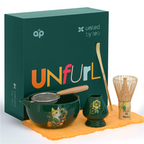 The Green Unfurl Matcha Gift Set includes a matcha bowl, whisk, strainer, scoop, and towel—all elegantly presented with a green "UNfurl" gift box for an elevated matcha tea experience.