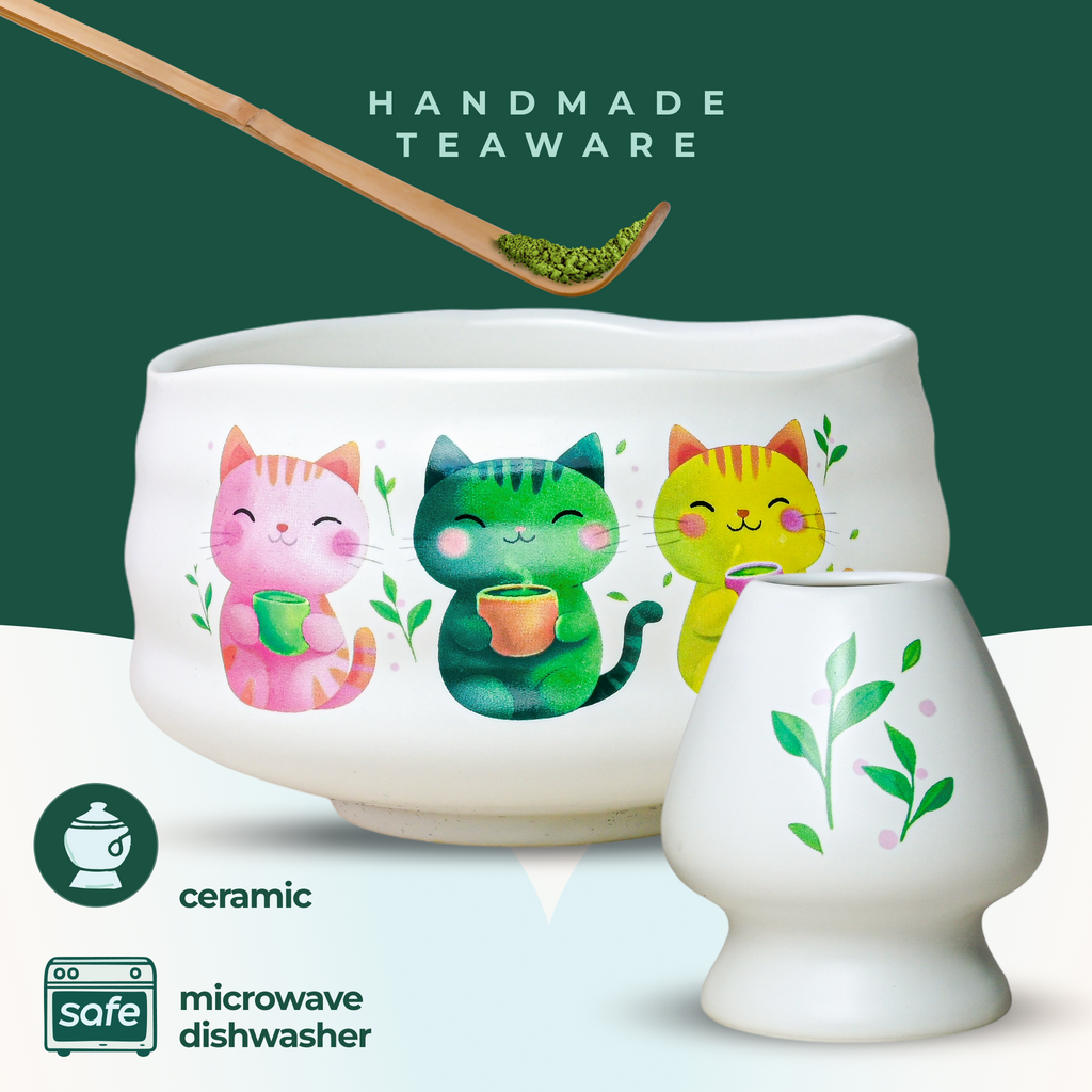 The White Unfurl Matcha Gift Set includes a ceramic teacup with three colorful cat illustrations, inspired by kawaii cat bowls, "handmade teaware" text, and safe-use icons.