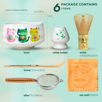 The White Unfurl Matcha Gift Set includes a kawaii cat bowl, whisk, holder, scoop, sifter, and an orange tea cloth on a light background.