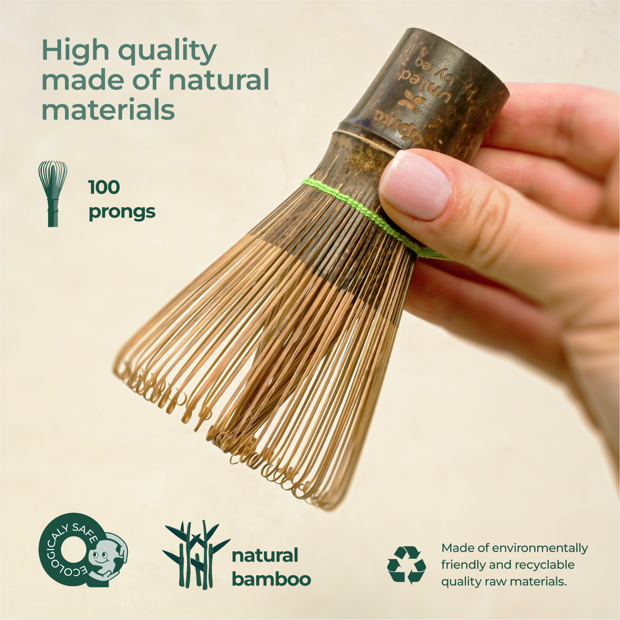 Hand holds a Dark Matcha Bamboo Whisk, crafted with 100 prongs for ceremonial Matcha tea. Eco-friendly and made from natural materials, it makes a unique gift idea.