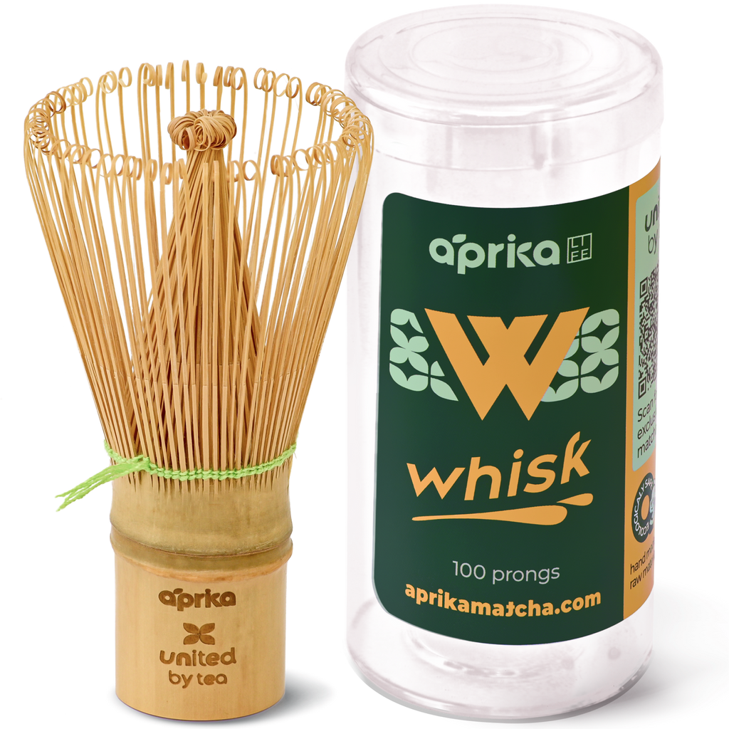 The eco-friendly Bamboo Matcha Whisk (100 Prongs) elegantly rests beside its sleek cylindrical packaging.